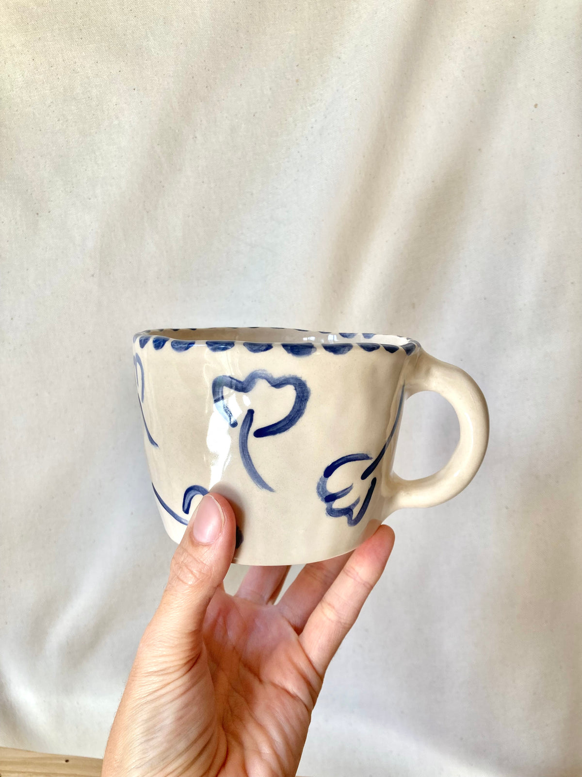 Large ceramic mug with blue flowers and blue polka dots