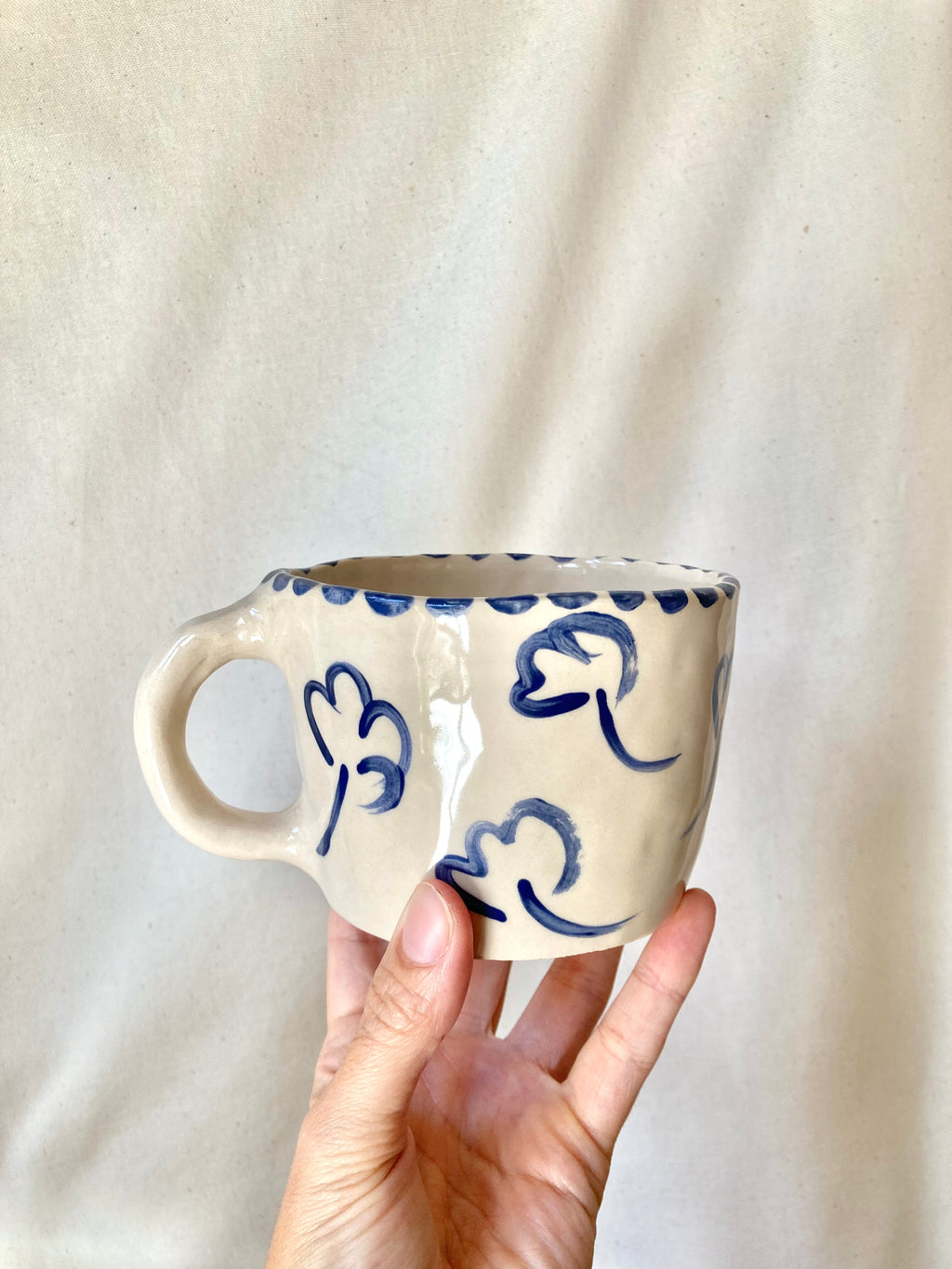 Large ceramic mug with blue flowers and blue polka dots
