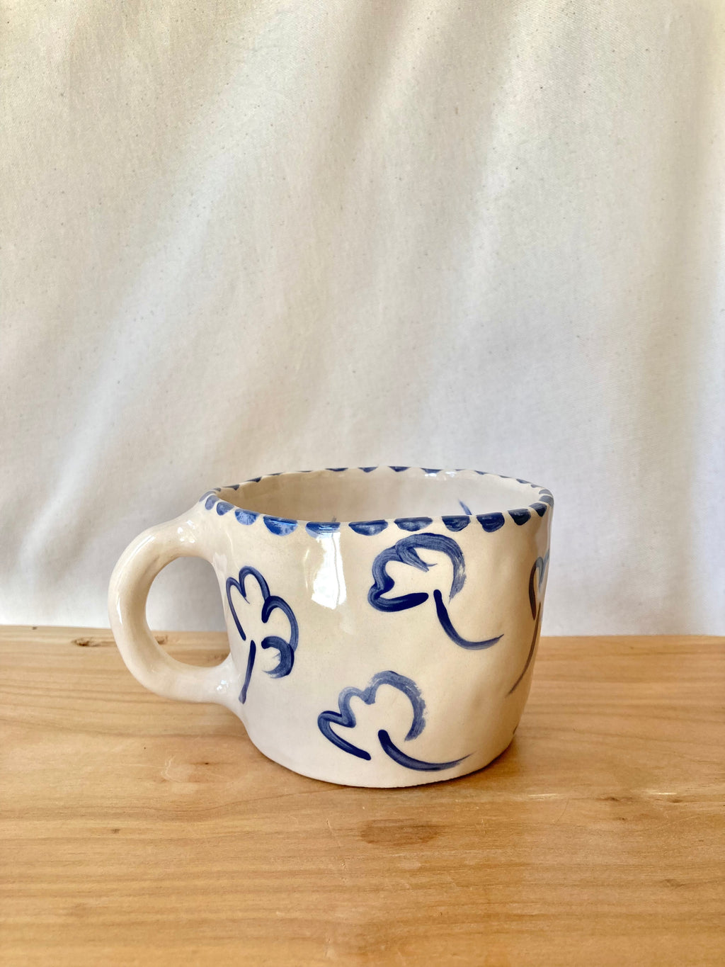 Large ceramic mug with blue flowers and blue polka dots